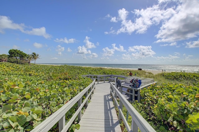 dock area featuring a water view and a view of the beach