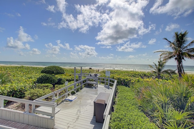 exterior space with a water view and a beach view