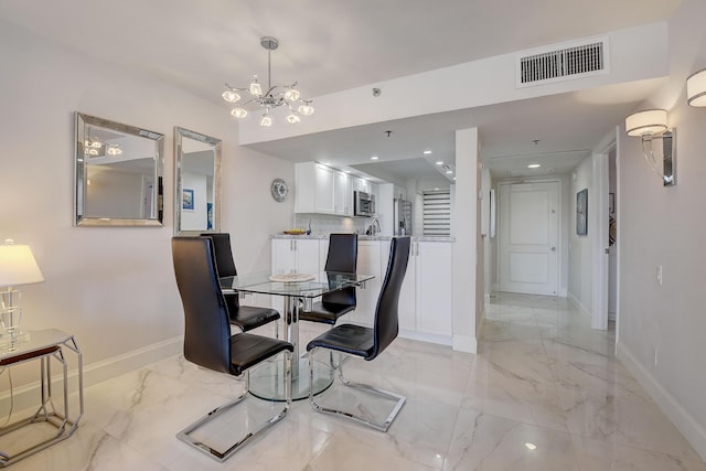 dining area featuring a notable chandelier