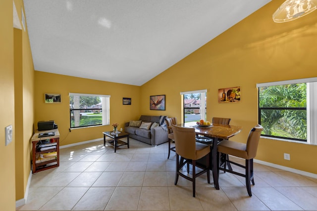 5951 Parkwalk Dr, Boynton Beach, FL 33472 - dining area with light tile patterned floors, high vaulted ceiling, and baseboards