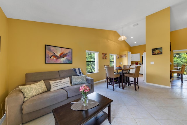 living room with high vaulted ceiling and light tile patterned floors