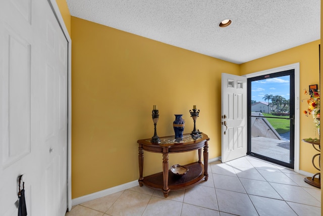 5951 Parkwalk Dr, Boynton Beach, FL 33472 - foyer entrance with baseboards, a textured ceiling, and light tile patterned floors