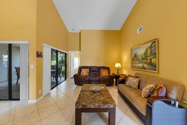 tiled living room featuring high vaulted ceiling