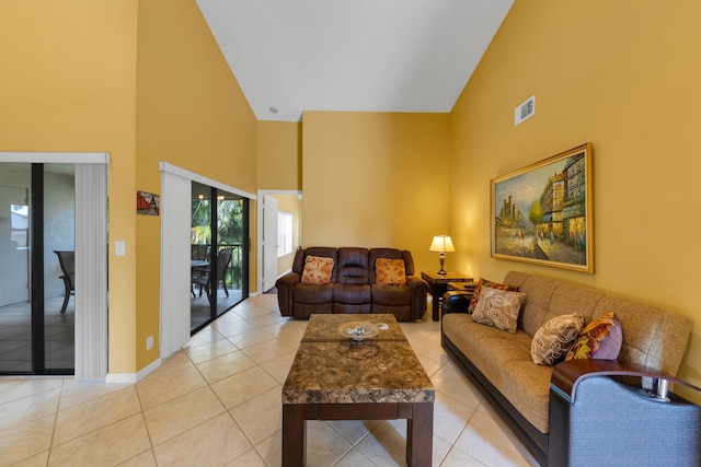 living room featuring high vaulted ceiling and light tile patterned flooring