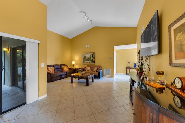 living room with light tile patterned floors, track lighting, and high vaulted ceiling