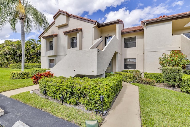 5951 Parkwalk Dr, Boynton Beach, FL 33472 - exterior space featuring stucco siding, a tile roof, and a front yard