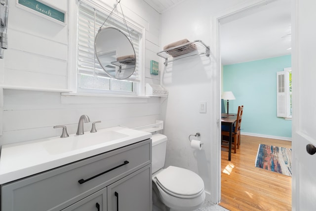 bathroom with vanity, wood-type flooring, and toilet