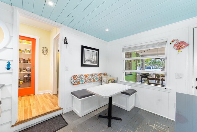 interior space with ornamental molding, wood ceiling, and breakfast area