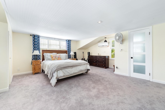 bedroom with light colored carpet and a wall mounted air conditioner