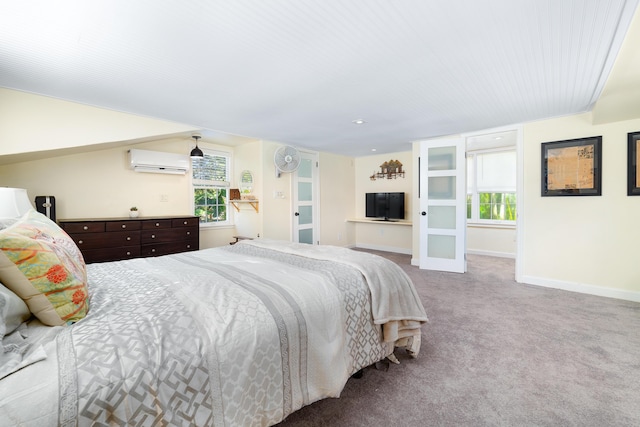 bedroom with a wall mounted air conditioner and light carpet