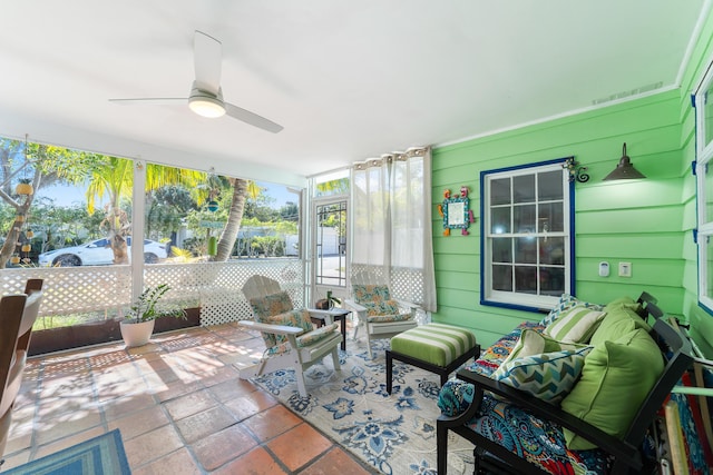 sunroom / solarium featuring ceiling fan