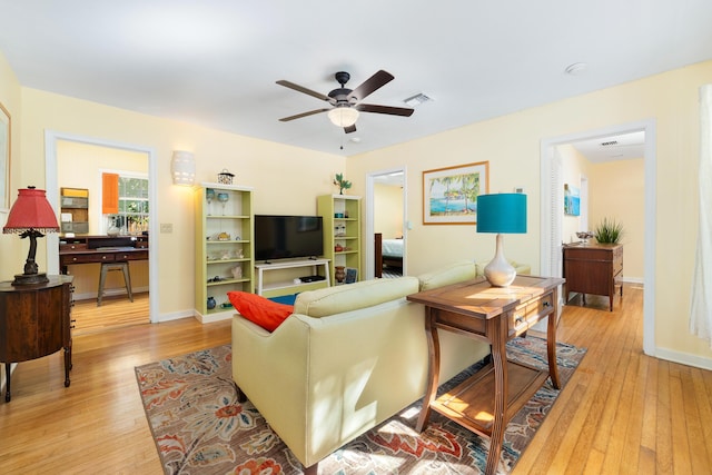 living room featuring ceiling fan and light wood-type flooring