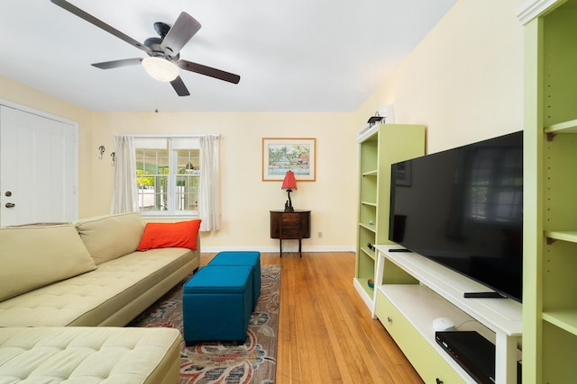 living room featuring hardwood / wood-style flooring and ceiling fan