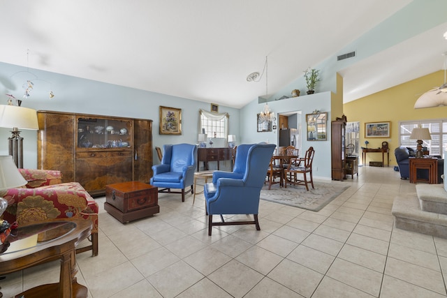 living room featuring lofted ceiling, light tile patterned floors, and plenty of natural light