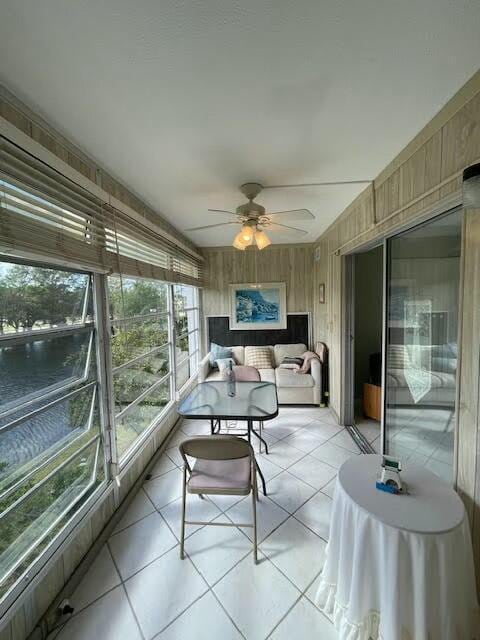 sunroom featuring ceiling fan