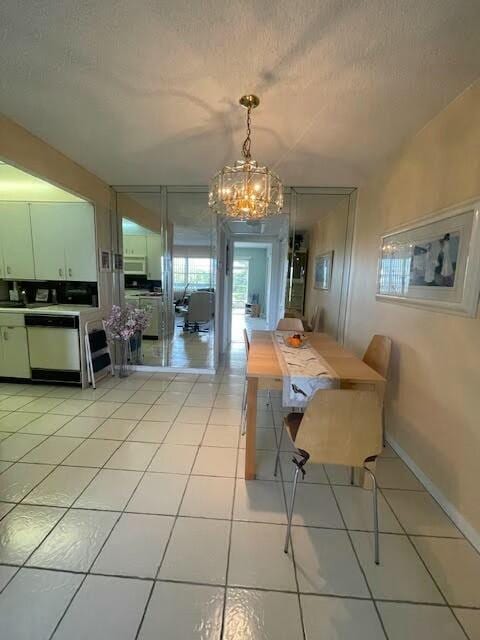 dining room featuring light tile patterned flooring, an inviting chandelier, and a textured ceiling