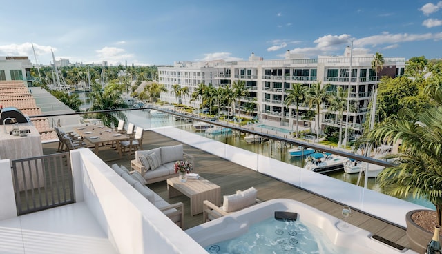 balcony featuring a water view and outdoor lounge area