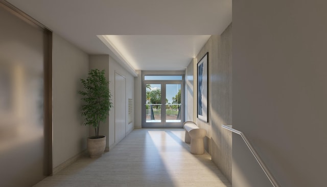 doorway to outside featuring french doors, expansive windows, and light hardwood / wood-style floors