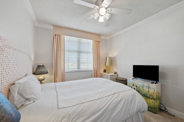 carpeted bedroom with ornamental molding, ceiling fan, and a textured ceiling