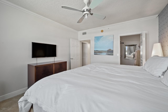 bedroom with crown molding, ceiling fan, carpet floors, and a textured ceiling