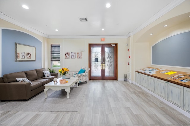 living room with light hardwood / wood-style flooring, ornamental molding, and french doors