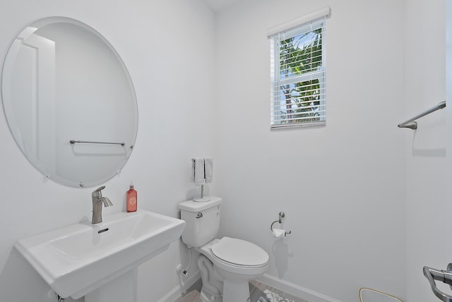 bathroom featuring toilet and sink