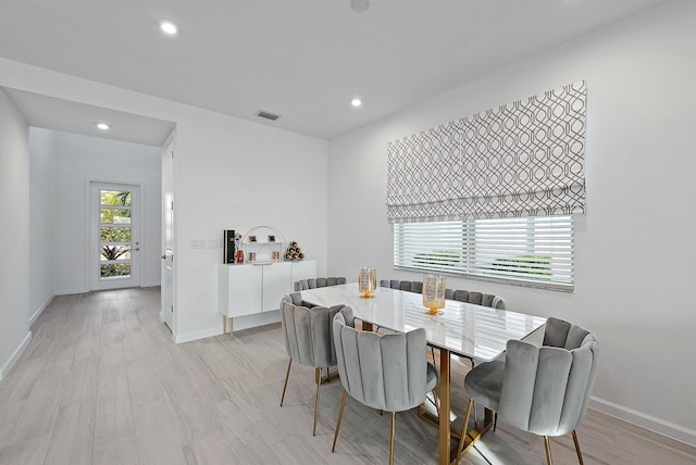 dining space with light wood-type flooring