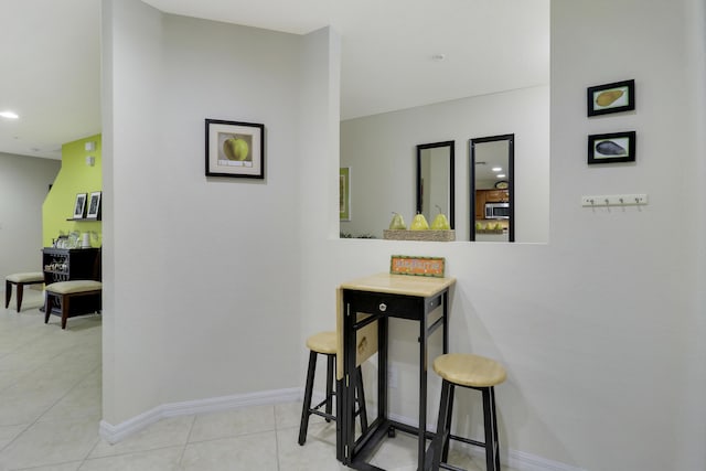 corridor featuring light tile patterned flooring