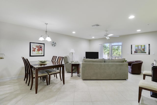 tiled living room featuring ceiling fan with notable chandelier