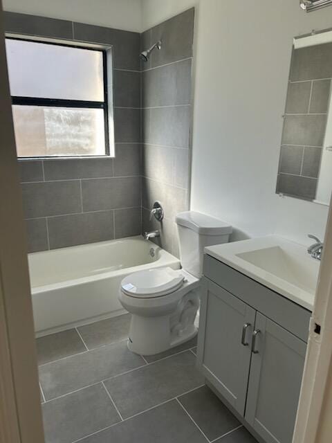 full bathroom with tile patterned flooring, vanity, toilet, and tiled shower / bath