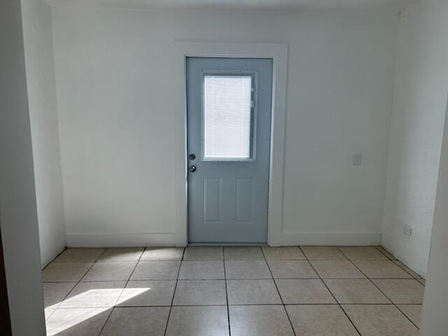 doorway featuring light tile patterned floors