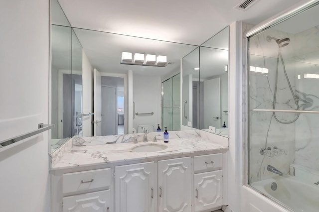 bathroom with vanity and shower / bath combination with glass door