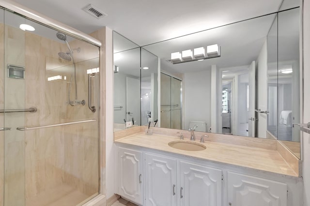 bathroom with vanity, toilet, and a shower with shower door