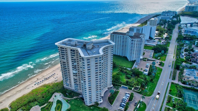 birds eye view of property featuring a beach view and a water view