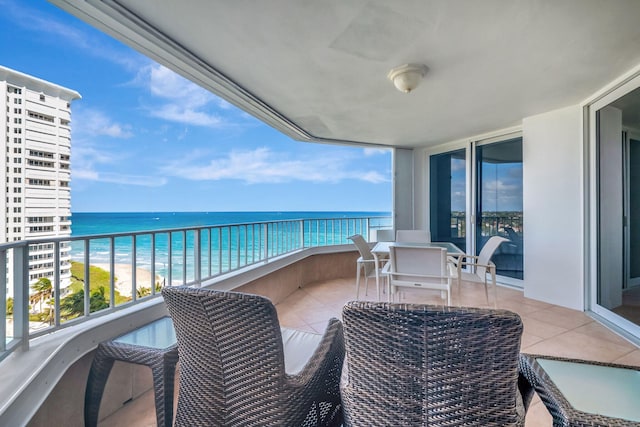 balcony with a water view and a beach view