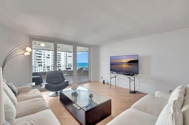 tiled living room with floor to ceiling windows