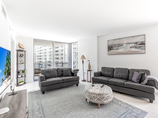 tiled living room with a wall of windows