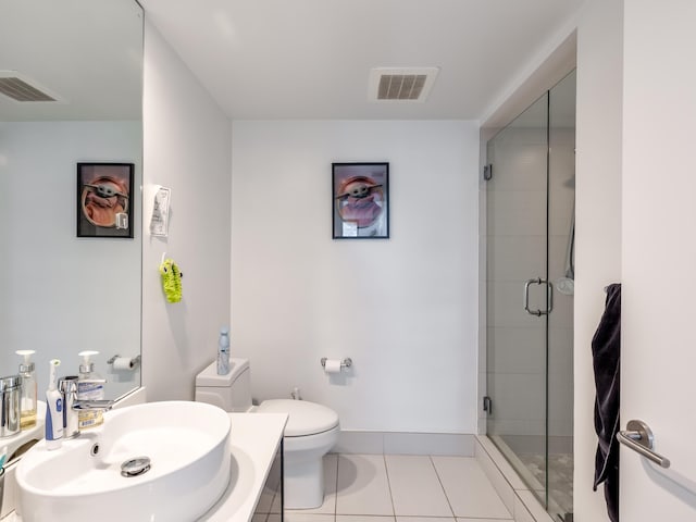 bathroom with an enclosed shower, vanity, tile patterned floors, and toilet