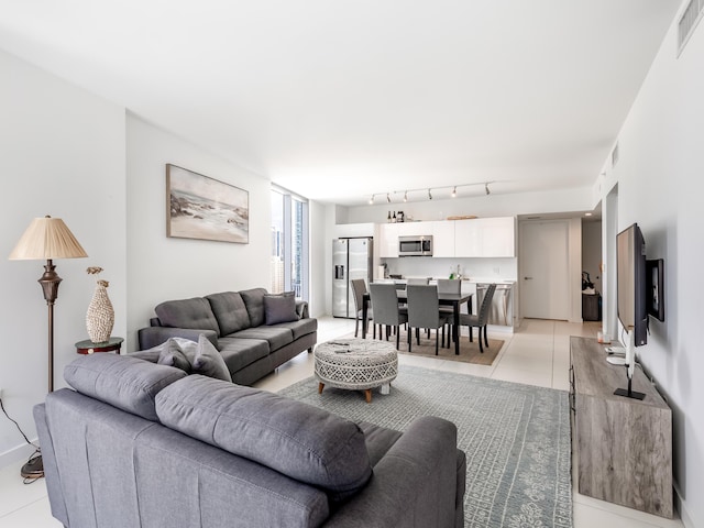 living room with light tile patterned floors and track lighting