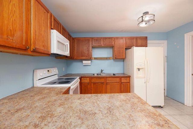 kitchen with sink, light tile patterned floors, and white appliances