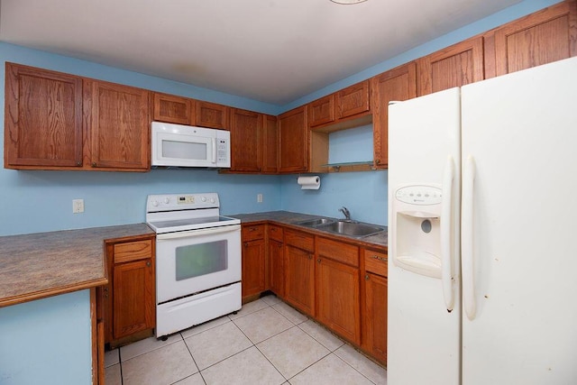 kitchen with white appliances, sink, and light tile patterned floors