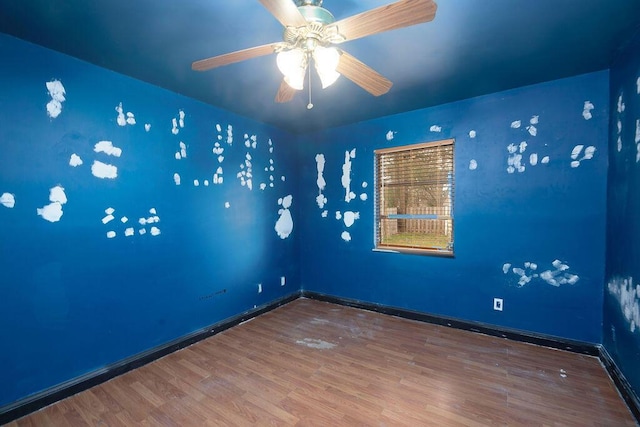 spare room featuring hardwood / wood-style floors and ceiling fan