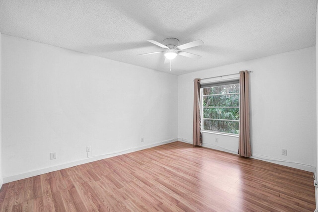 empty room featuring a textured ceiling, wood-type flooring, and ceiling fan