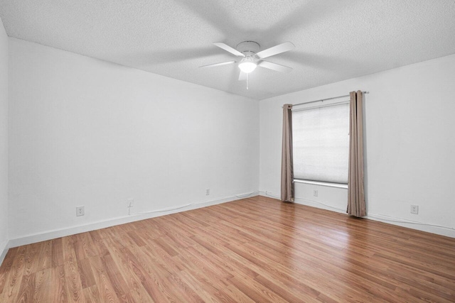 spare room featuring a textured ceiling, wood-type flooring, and ceiling fan