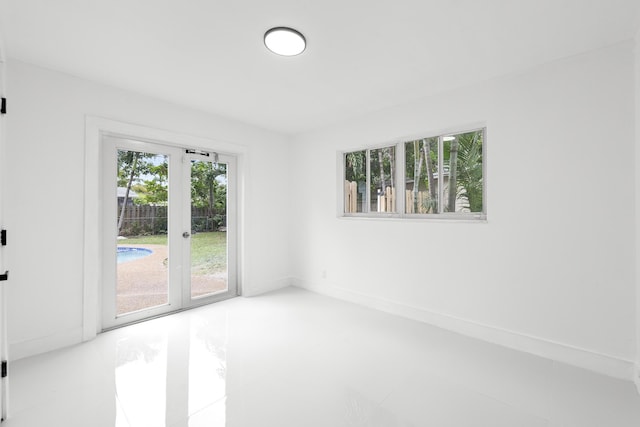 unfurnished room featuring french doors