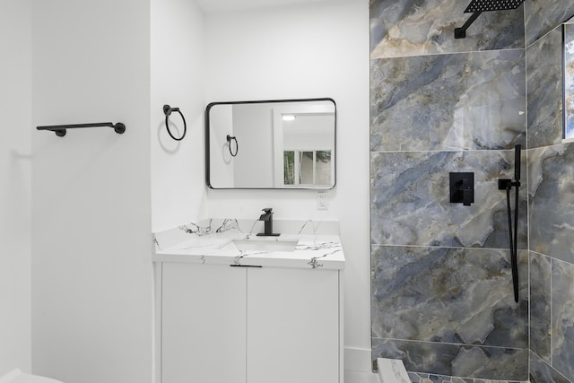 bathroom featuring vanity and tiled shower