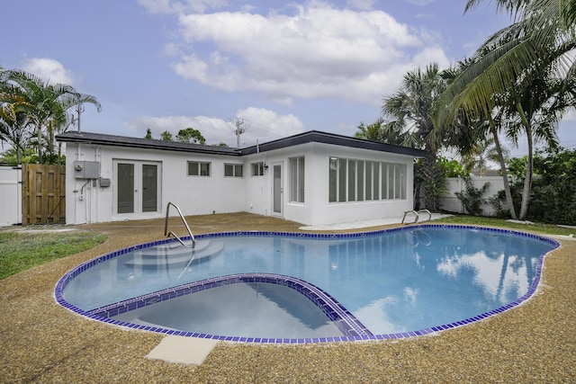 view of pool with french doors