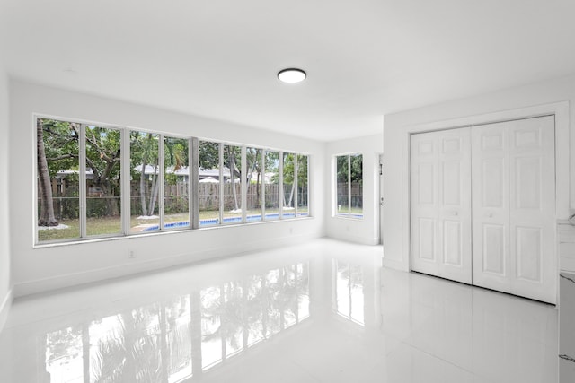 interior space featuring light tile patterned floors and a closet