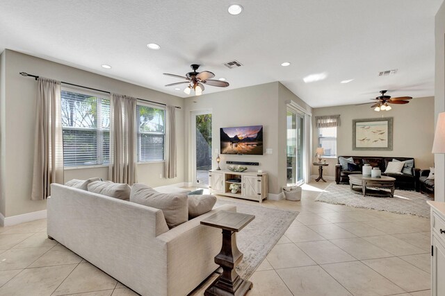 kitchen with sink, a breakfast bar area, dark stone counters, an island with sink, and stainless steel appliances