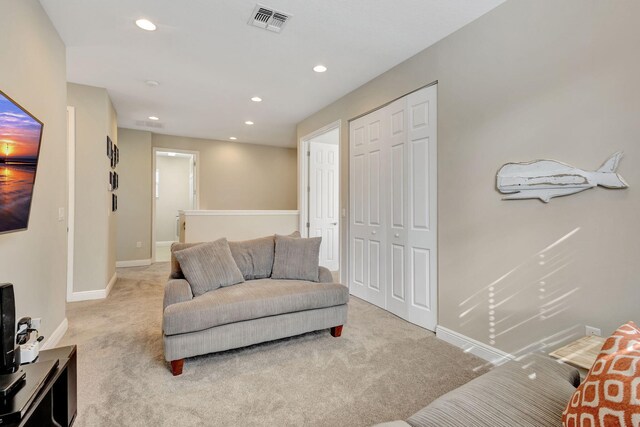 carpeted bedroom with ceiling fan and a closet